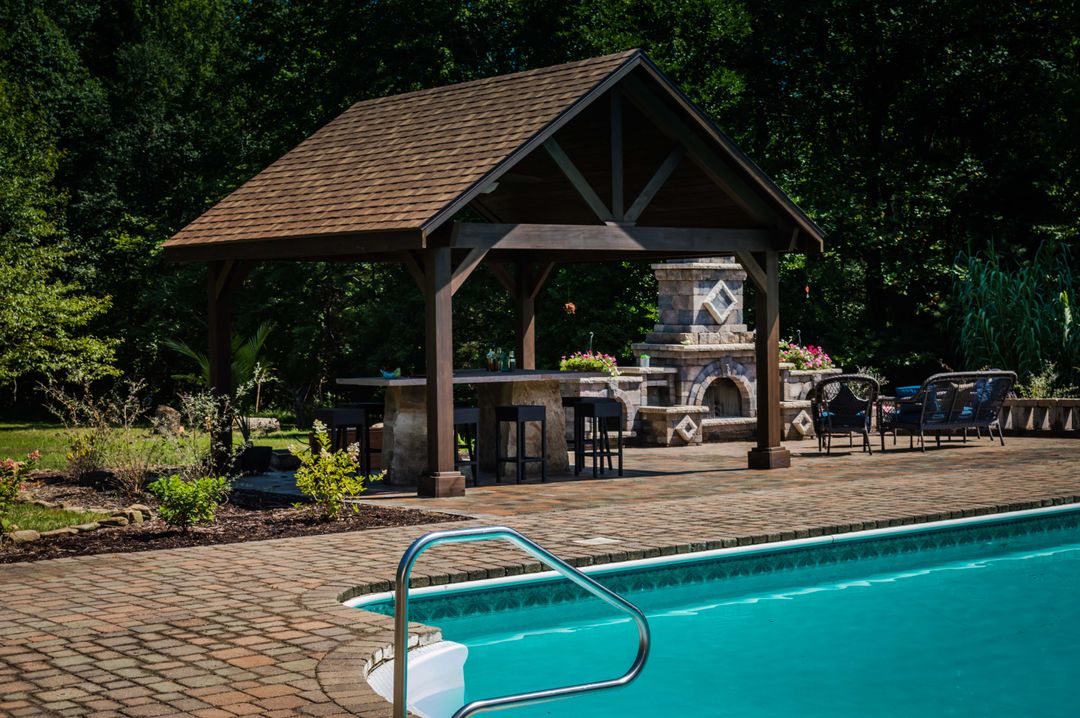 Outdoor patio with pool and wooden gazebo