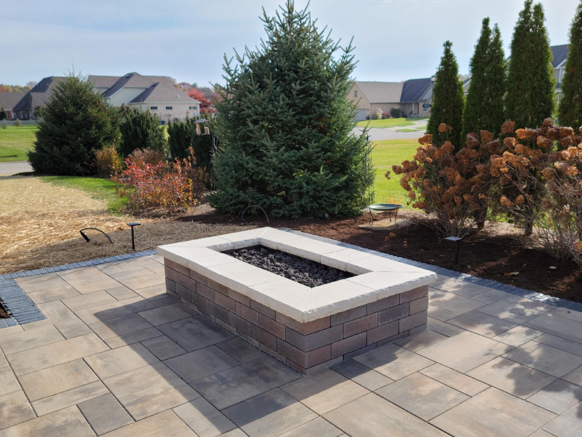 Outdoor patio with a brick fire pit.