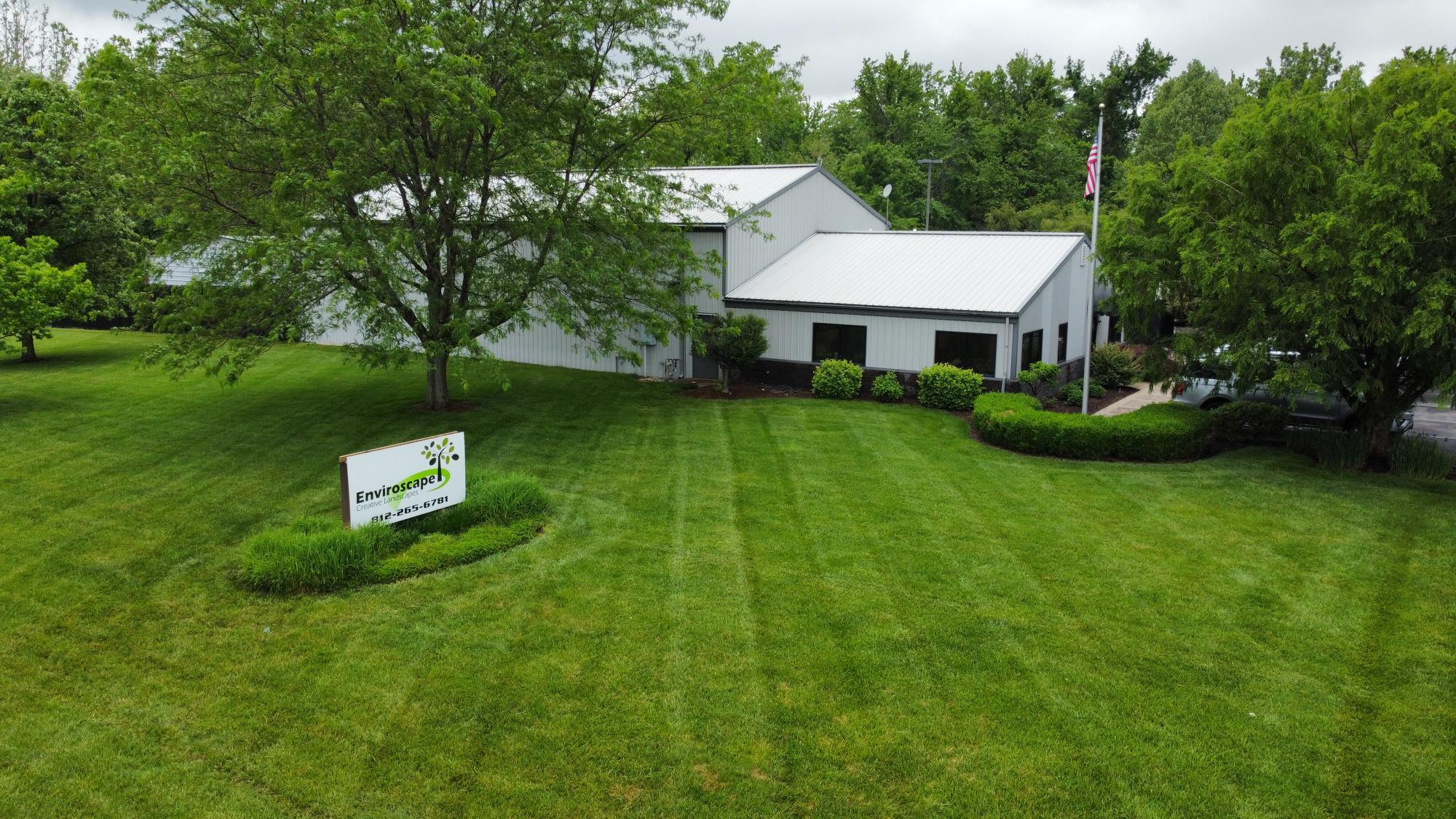 Building with greenery and sign in front yard