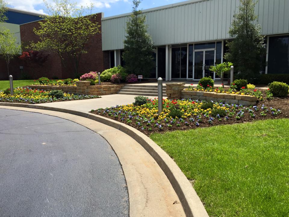Building entrance with vibrant flower garden