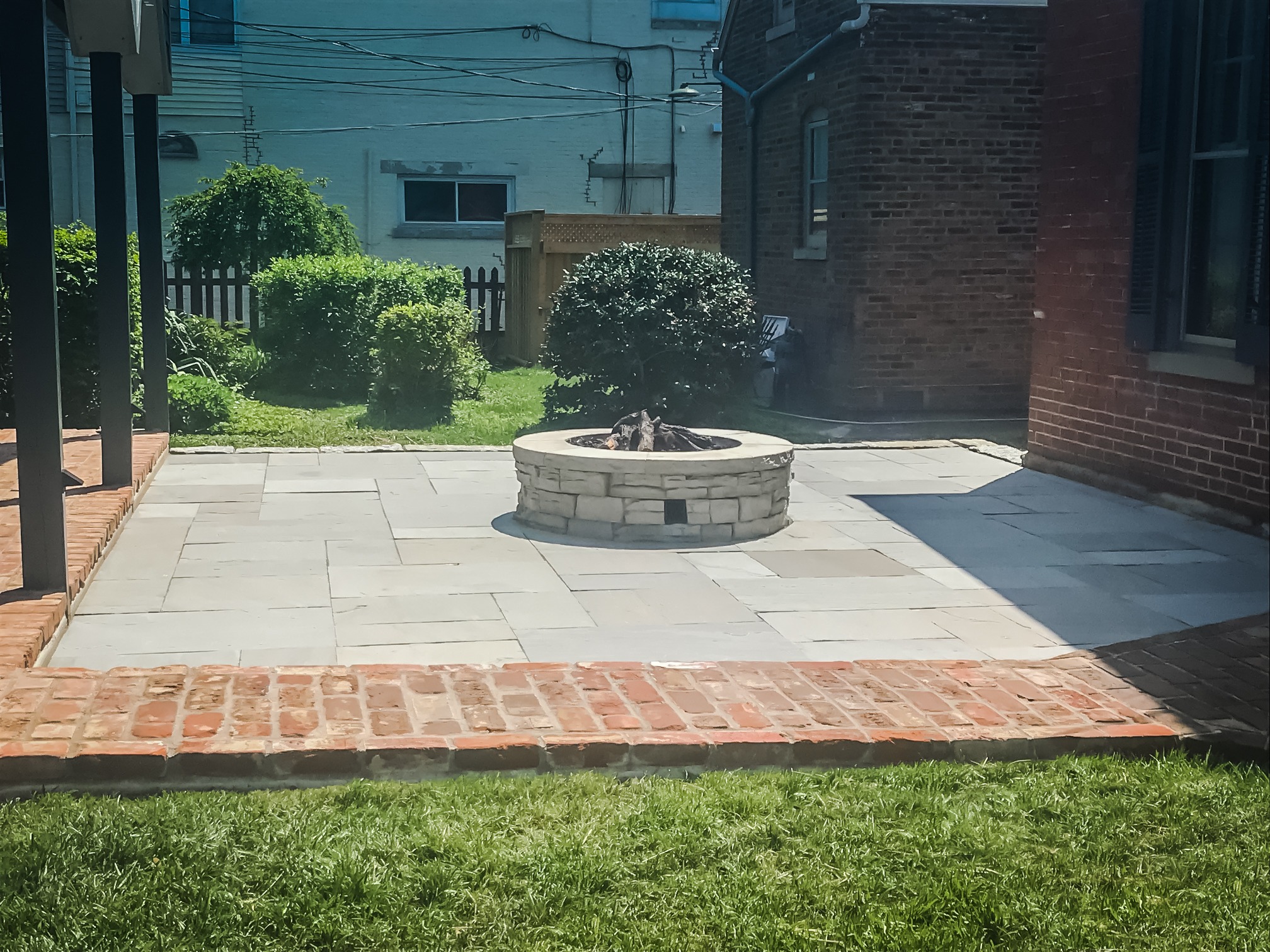 Outdoor patio with brick fire pit.