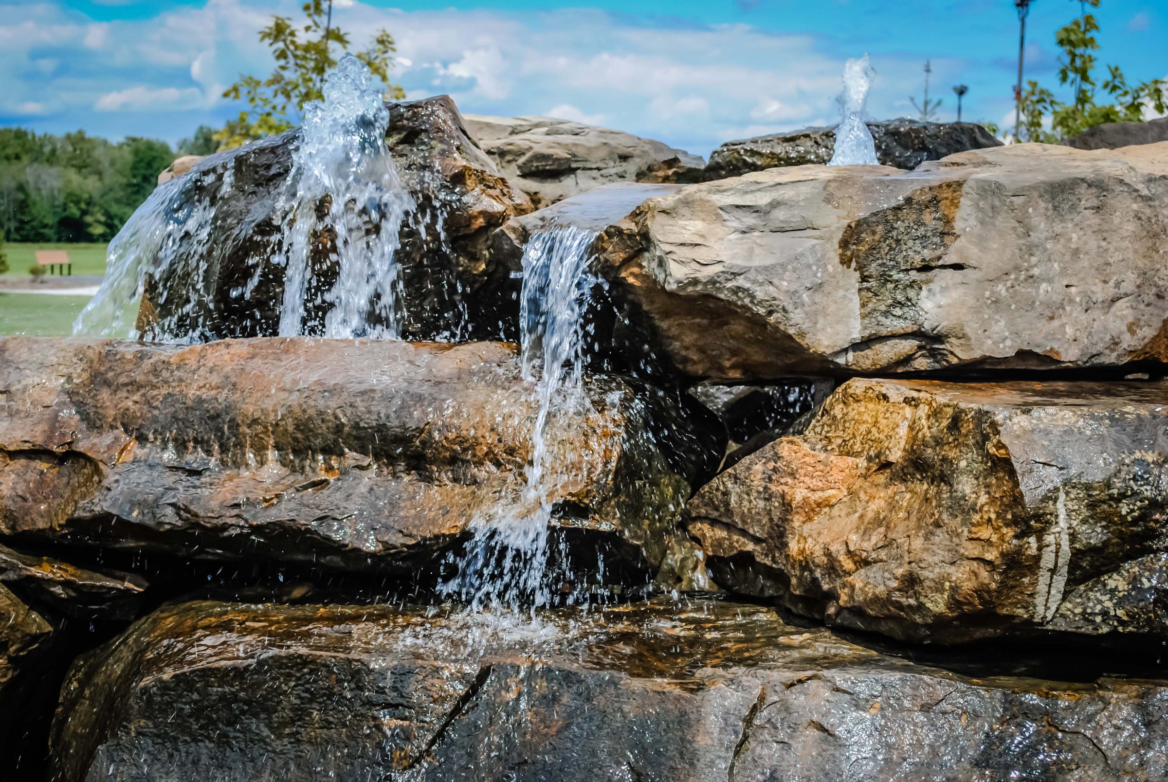 Waterfall cascading over large rocks in park