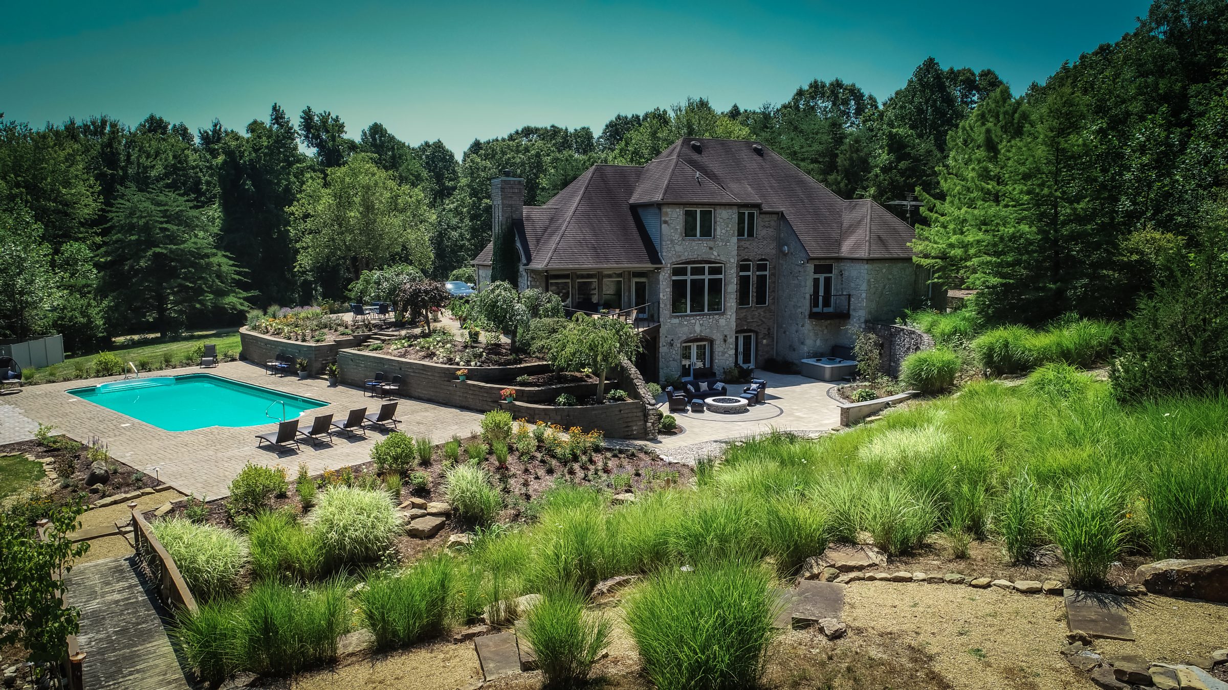 Luxury home with pool and garden in lush setting.