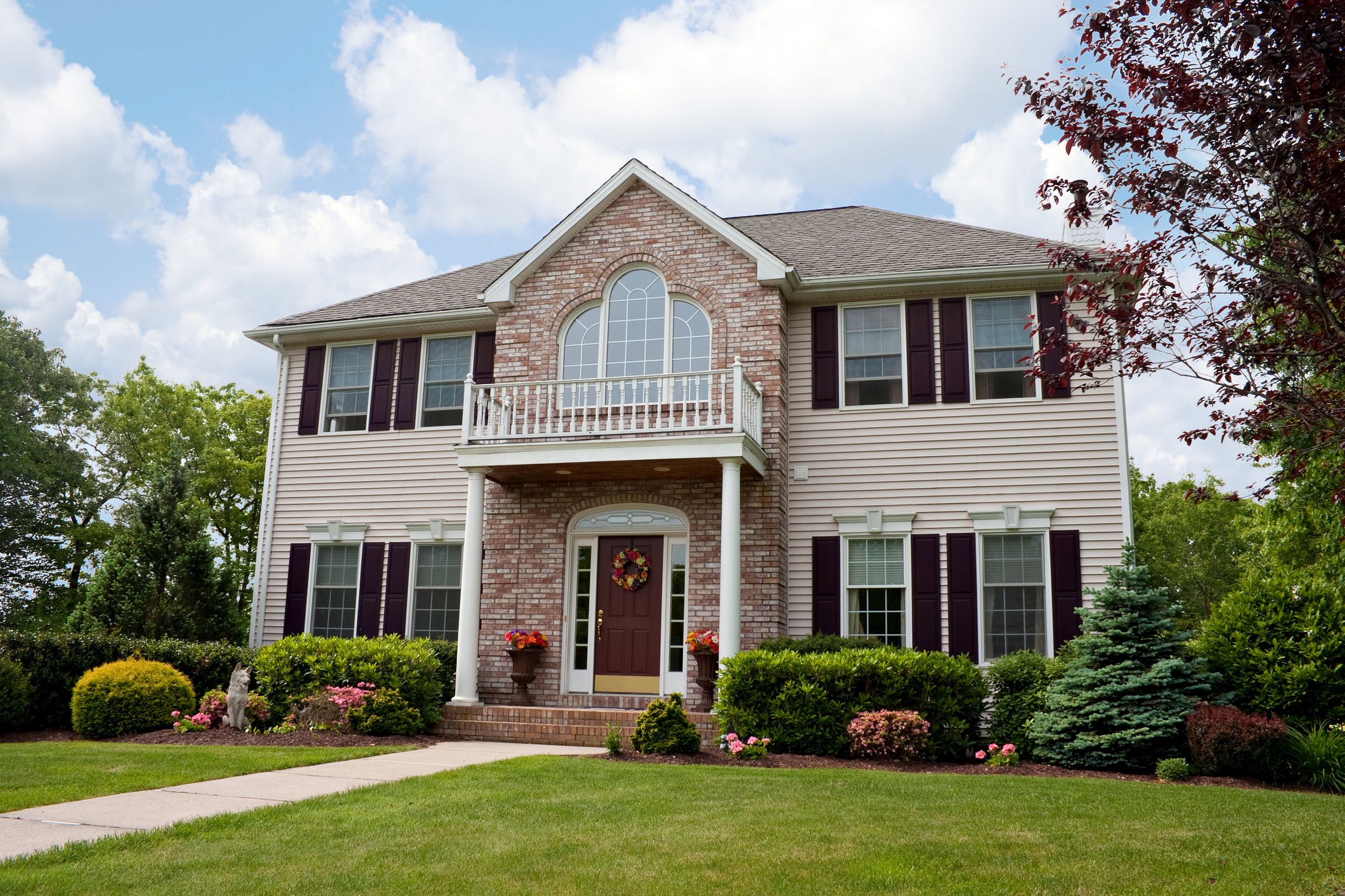 Suburban two-story brick house with garden