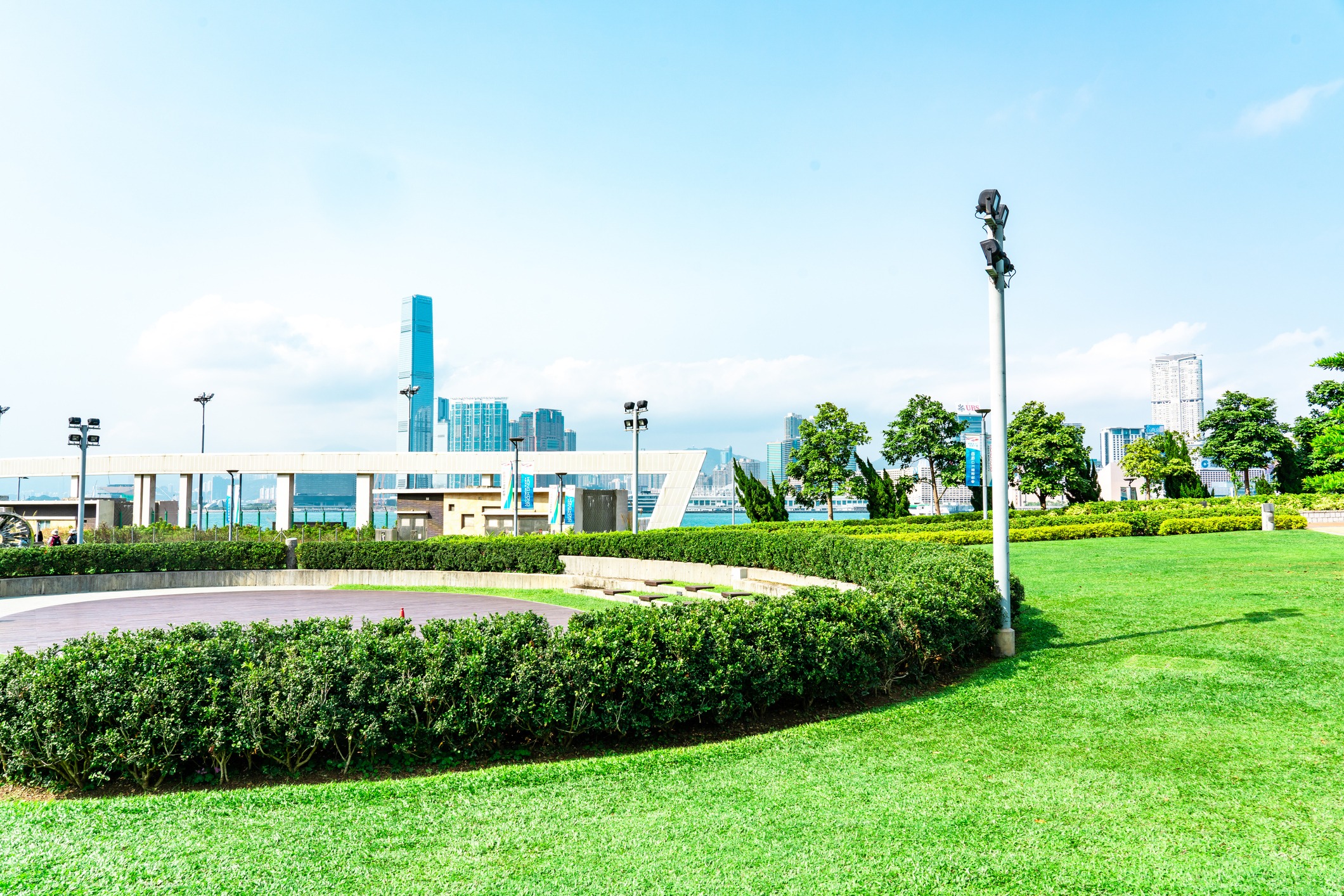 Green park with city skyline and trees.