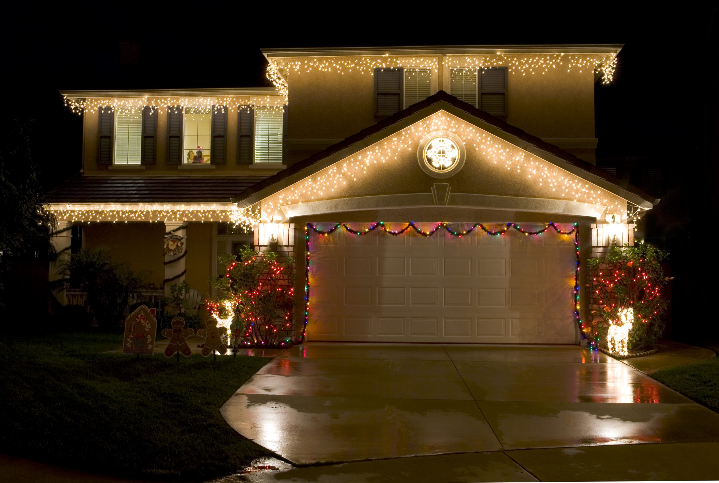 House decorated with Christmas lights at night.