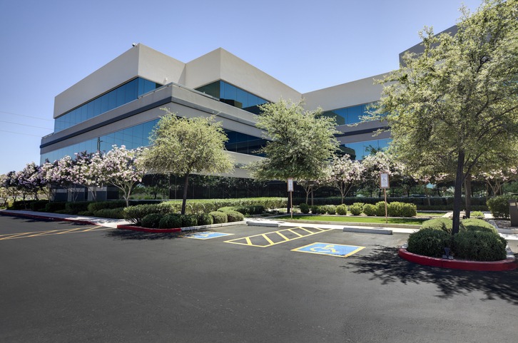 Modern office building with accessible parking spaces.