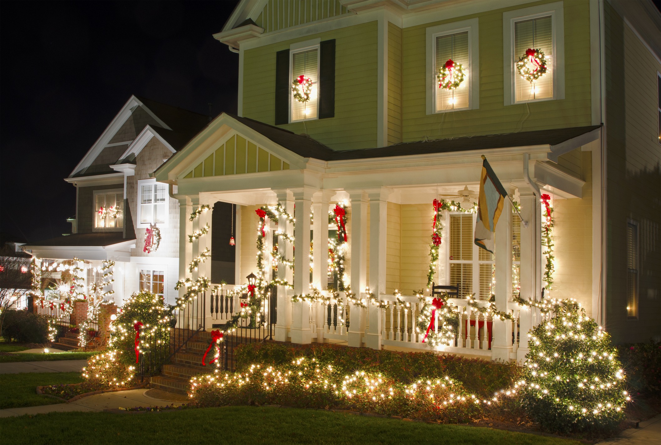 House decorated with Christmas lights and wreaths.
