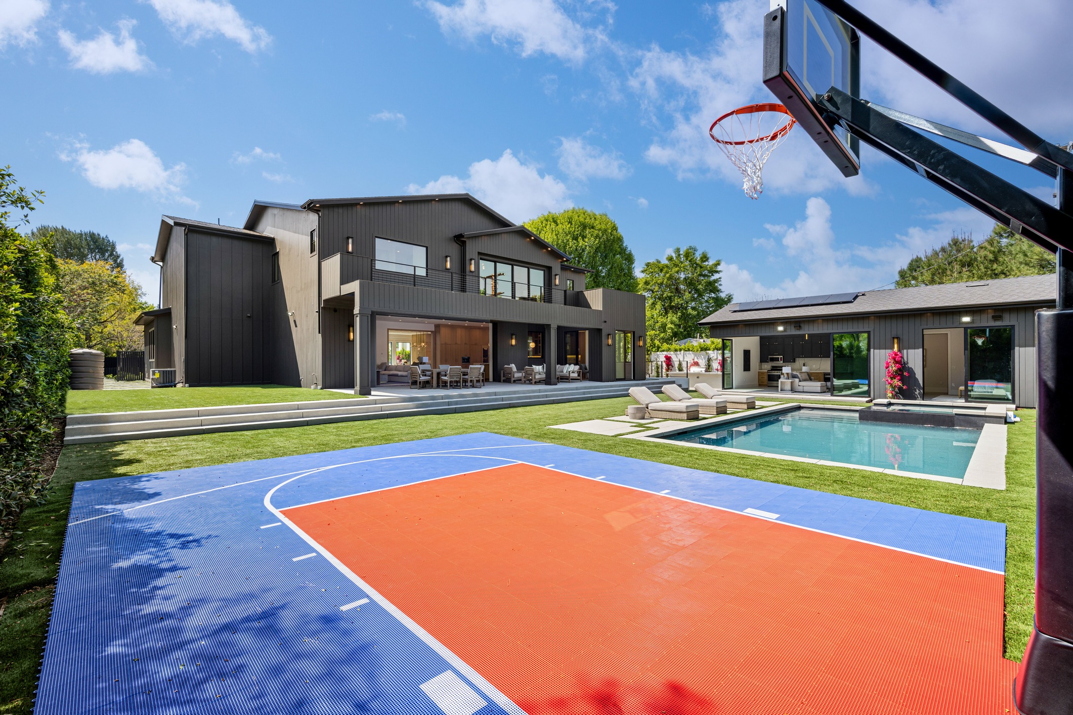 Modern home with pool and basketball court