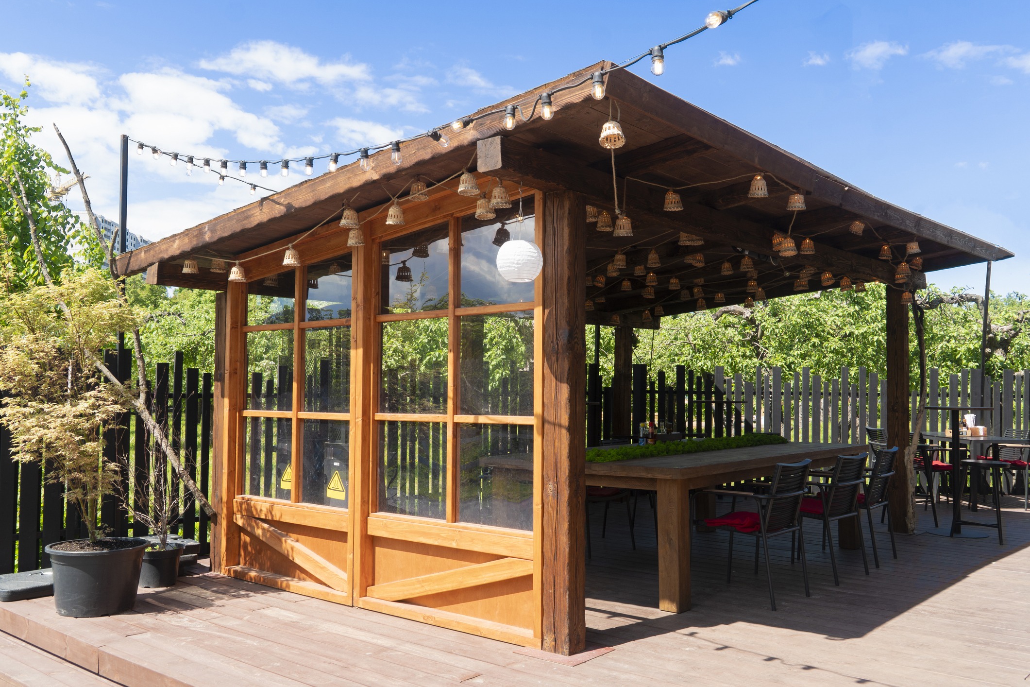 Rustic wooden patio dwelling with outdoor seating.