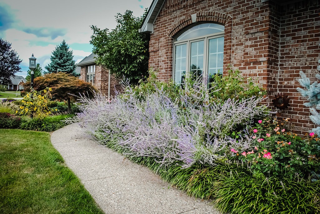 Brick house with lush garden pathway