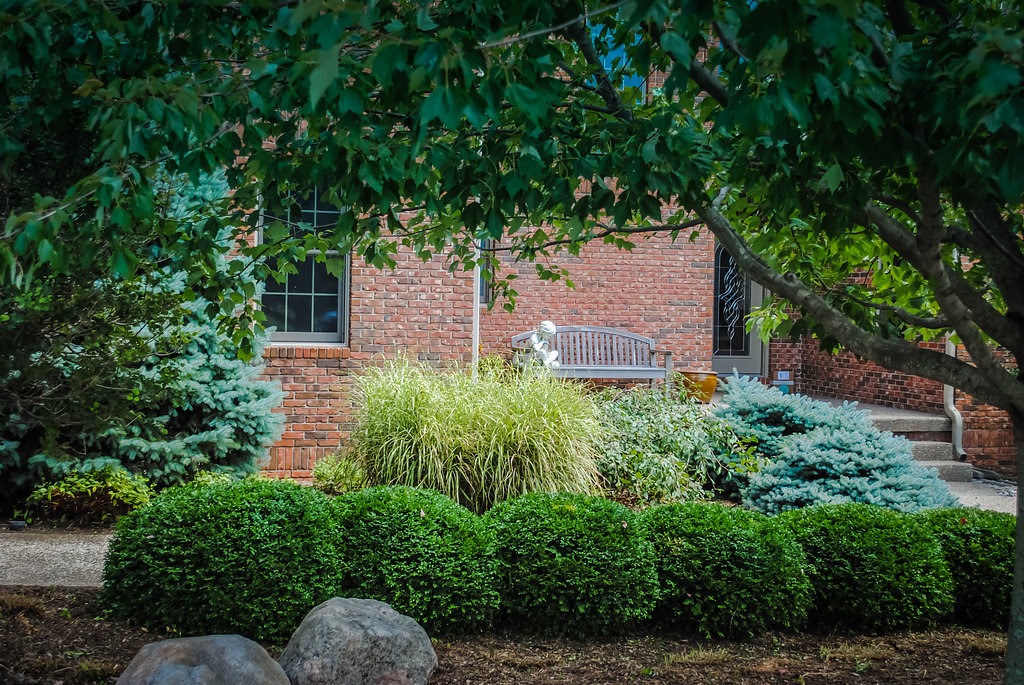 Brick house with garden and bench