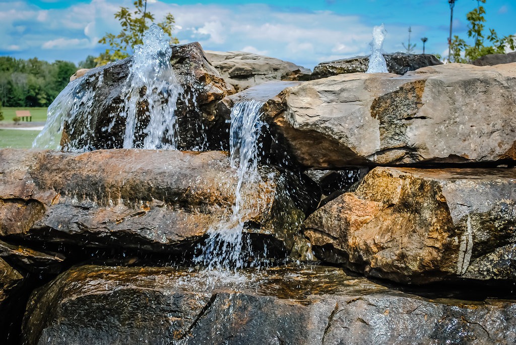 Rock waterfall with cascading water outdoors.